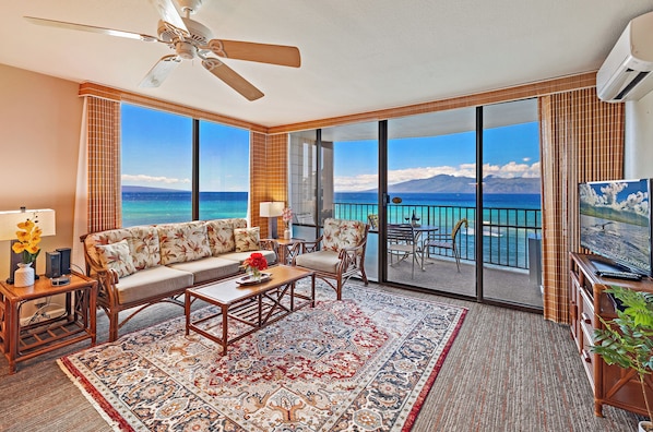 Condo living room featuring panoramic view of famous sandy Kahana beach, Maui!