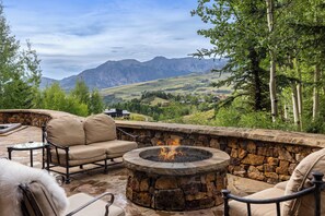 Outdoor private firepit on downstairs patio overlooking the San Sophia range and golf course