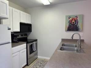 Kitchen area. All plates, utensils, cups and cookware are found in the cabinets.
