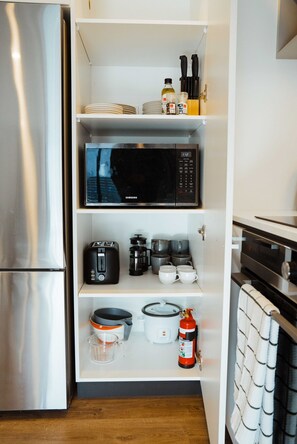 Samsung microwave, rice cooker, Westinghouse toaster, fire extinguisher.