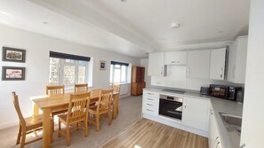 Full Kitchen & open plan Dining Room, with dishwasher, washing machine, microwa