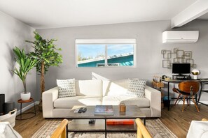 Living room fit for lounging with friends and family. Dedicated workspace available, as well.