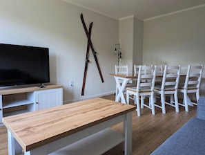 Modern eingerichtetes Wohnzimmer mit Sofa und Esstisch