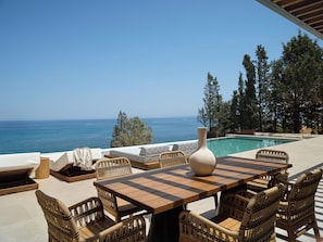 The villa outdoor pool settings, featuring swim up sun-beds 