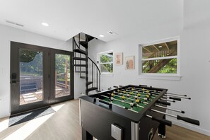 Enjoy our bright game room with foosball and easy outdoor access.