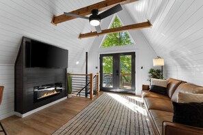 Enjoy the charm of our modern A-frame living room with a warm fireplace.