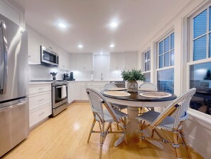 Kitchen with round dining table that seats four. 