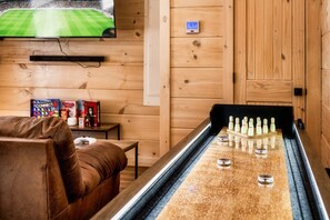 Unwind with games, shuffleboard, and entertainment in this cozy cabin space!