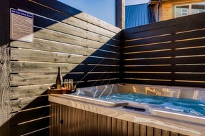 Relax in the private hot tub oasis, perfect for unwinding under the open sky.