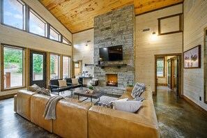 The living room is the heart of the cabin! Featuring a spacious sectional, gas fireplace, and a TV with DISH.