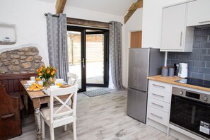 Kitchen/dining area with patio tables leading to the garden