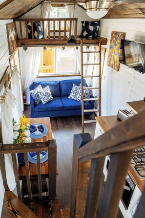 Ladder access to the mini loft. Sleeping for small person w/ comfy mat & linens.