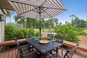 The villa's outdoor patio has a wooded view of the driving range, ideal for savoring your morning coffee or enjoying an evening BBQ under the stars.
