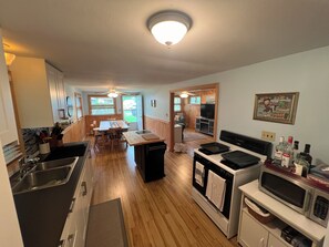 Updated kitchen w fridge, microwave and gas stove