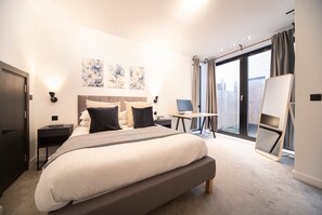 Double bedroom with a king-size bed, desk, and monitor