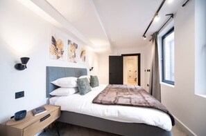 Ensuite bedroom with a king-size bed and a private bathroom with a shower