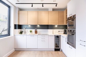 Fully equipped kitchen with amenities such as a dishwasher, Nespresso machine, and induction hob