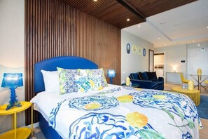 Integrated living, bedroom, and kitchen spaces in an open layout.