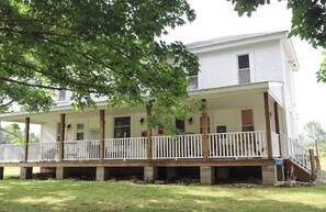One of the best features about your stay is the huge farmhouse porch complete with rocking chairs, fire table, games and plenty of room for everyone in your party. 