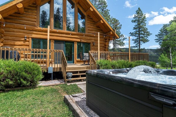 The hot tub features a stunning design that seamlessly blends with the patio's aesthetic.