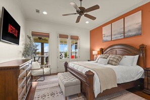 Master bedroom, with king bed, attached bathroom, 50" TV, and walkout doors to the porch.