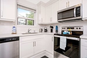 Fully equipped kitchen with a dishwasher and other appliances.