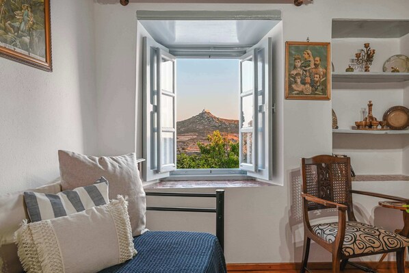 The living room on the upper floor with the magnificent view of the chapel of Prophet Elias.