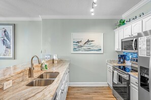 The fully equipped kitchen features granite countertops and stainless-steel appliances and has everything you need to prepare meals for family & friends.