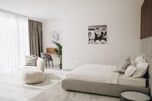 Luxury bedroom with double bed, en-suite bathroom, and sea view in Luxury family villa