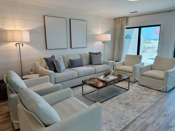 Modern coastal cream and blue living room with beach access.