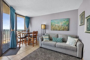 Relax in this cozy living and dining space with stunning ocean views! 