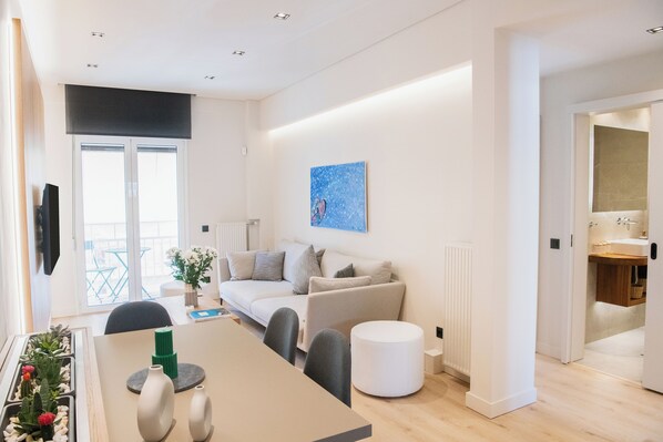 Living room with a sofa that can be transformed to a single bed, & a SAMSUNG TV