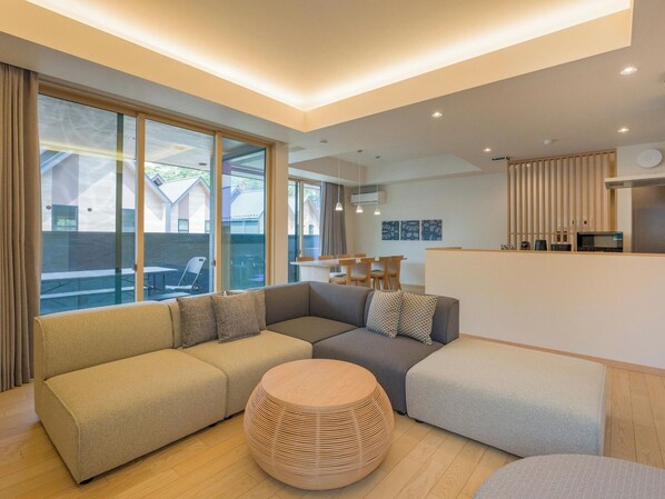 [Living/dining room] The large windows make the room feel larger and more open.
