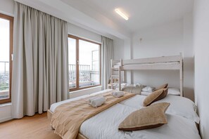 Bedroom 1 with a twin bed and a bunk bed with an adjacent terrace