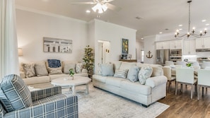 Spacious open-concept living area with elegant furnishings and modern finishes, perfect for family gatherings and entertaining.