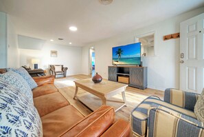 Comfortable chairs and TV setup in the inviting living room.