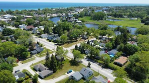 OVERALL:  Aerial view of the house (at the bottom) with the Au Sable River, downtown Oscoda, and Lake Huron in the background.