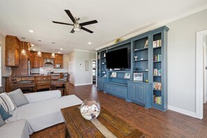 The open floor plan has a built-in cabinetry to provide ample space for guests in the living area.