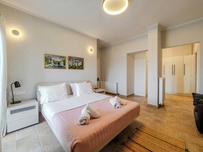 "Indulge in the epitome of comfort and style as you unwind in this chic bedroom haven, adorned with tasteful furnishings and soothing ambiance"