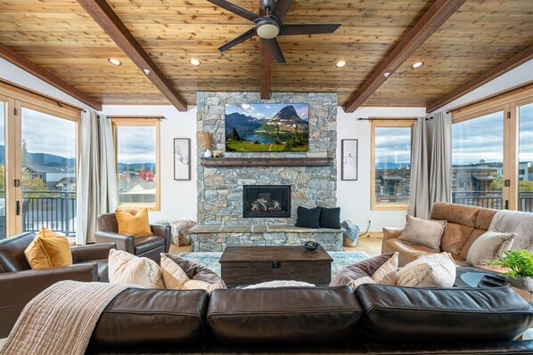 Framed by accordion doors & a wood-inlaid ceiling, the living room is a beautiful space for the whole group to gather.