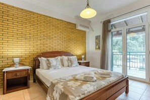 Master Bedroom Comfort: The spacious master bedroom on the first floor with access to a balcony offering stunning views.