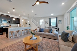 Integration of the living room, kitchen and dining room.