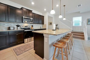 The kitchen has a large and spacious countertop for a delicious breakfast.