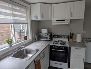 Fully stocked kitchen includes, fridge, stove, and dishwasher.