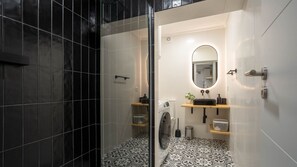 Modern bathroom with a washer & dryer for your convenience. #Bathroom #Washer