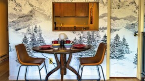 [1st Floor] Dining table for 2 with the wallpaper backdrop of the Alps. 