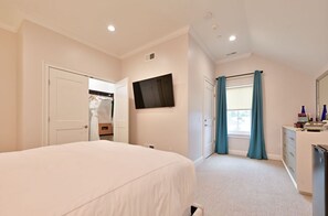 Cozy bedroom with a plush bed, soft lighting, and a convenient ensuite bathroom for added privacy.