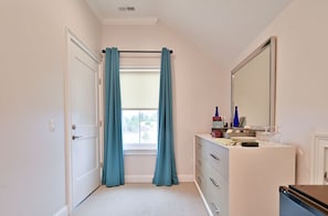 Bright and airy bathroom with modern fixtures, a large mirror, and plenty of natural light for a refreshing experience.