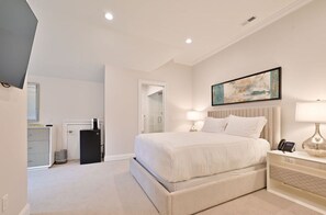 Spacious bedroom with a comfortable plush bed, stylish decor, and ample natural light for a serene retreat.