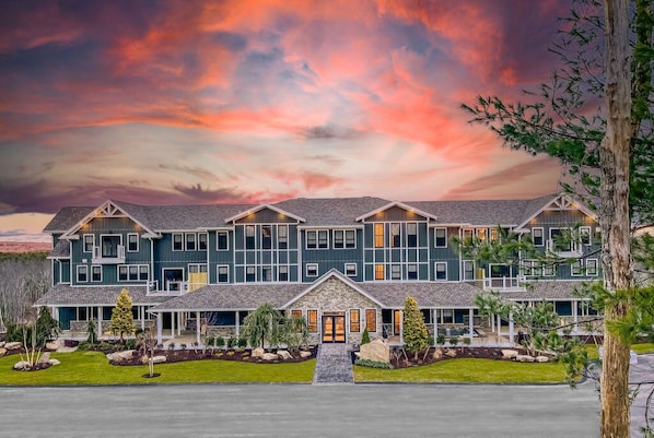 Hilltop Lodge - The setting sun envelops the lodge in a warm embrace, highlighting the architectural brilliance and stately beauty of the property.